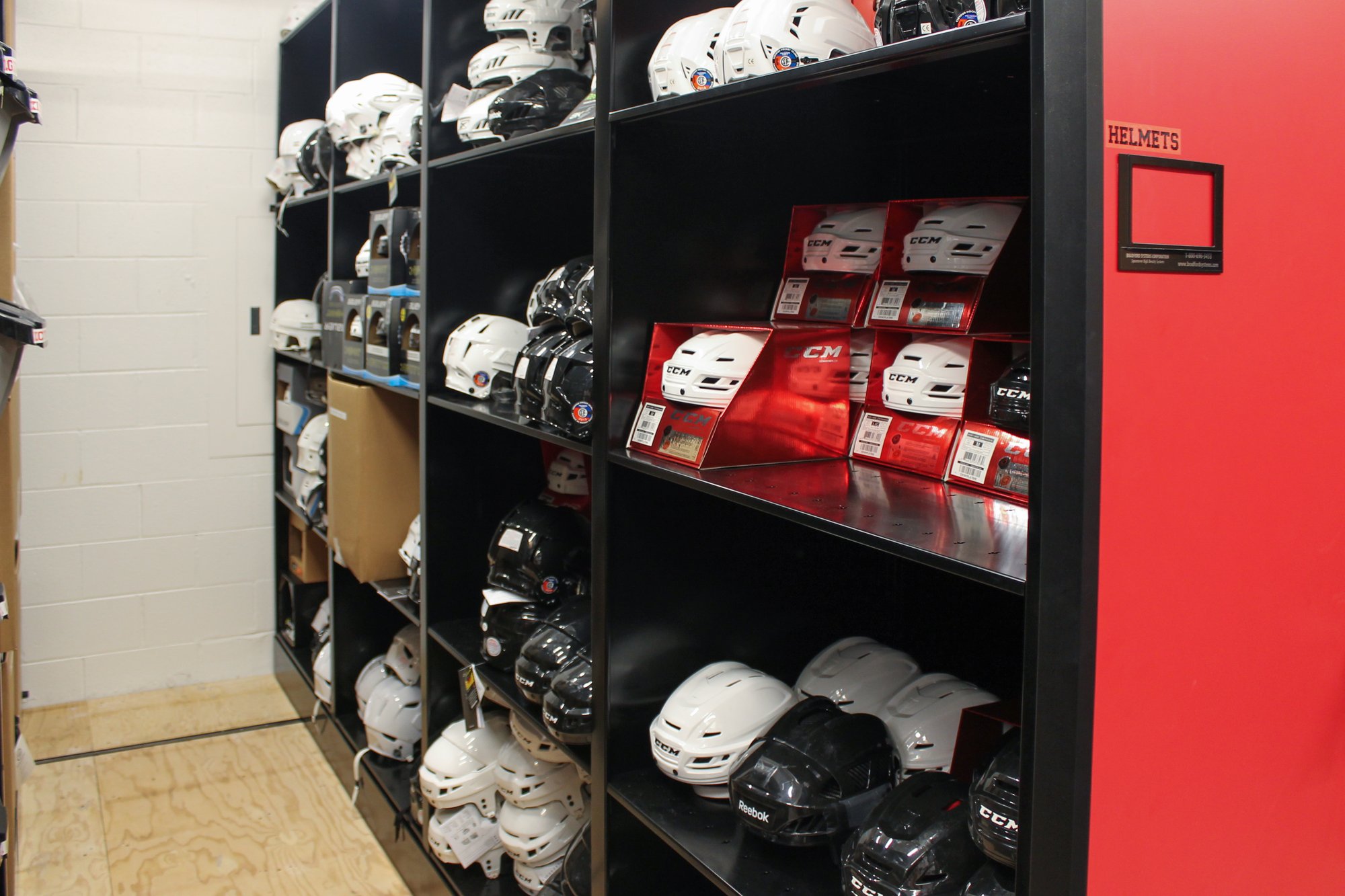 Helmet Hockey athletic equipment stored on 4-post shelving