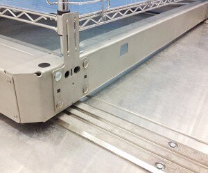Detail of rail and carriage system for compact cold storage. We can mount existing shelving on carriages, or custom engineer shelving to your specifications.