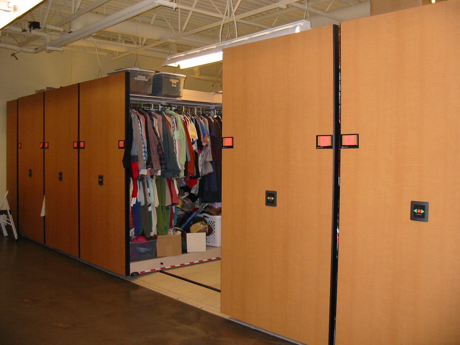Theater costumes and storage on powered compact mobile shelving