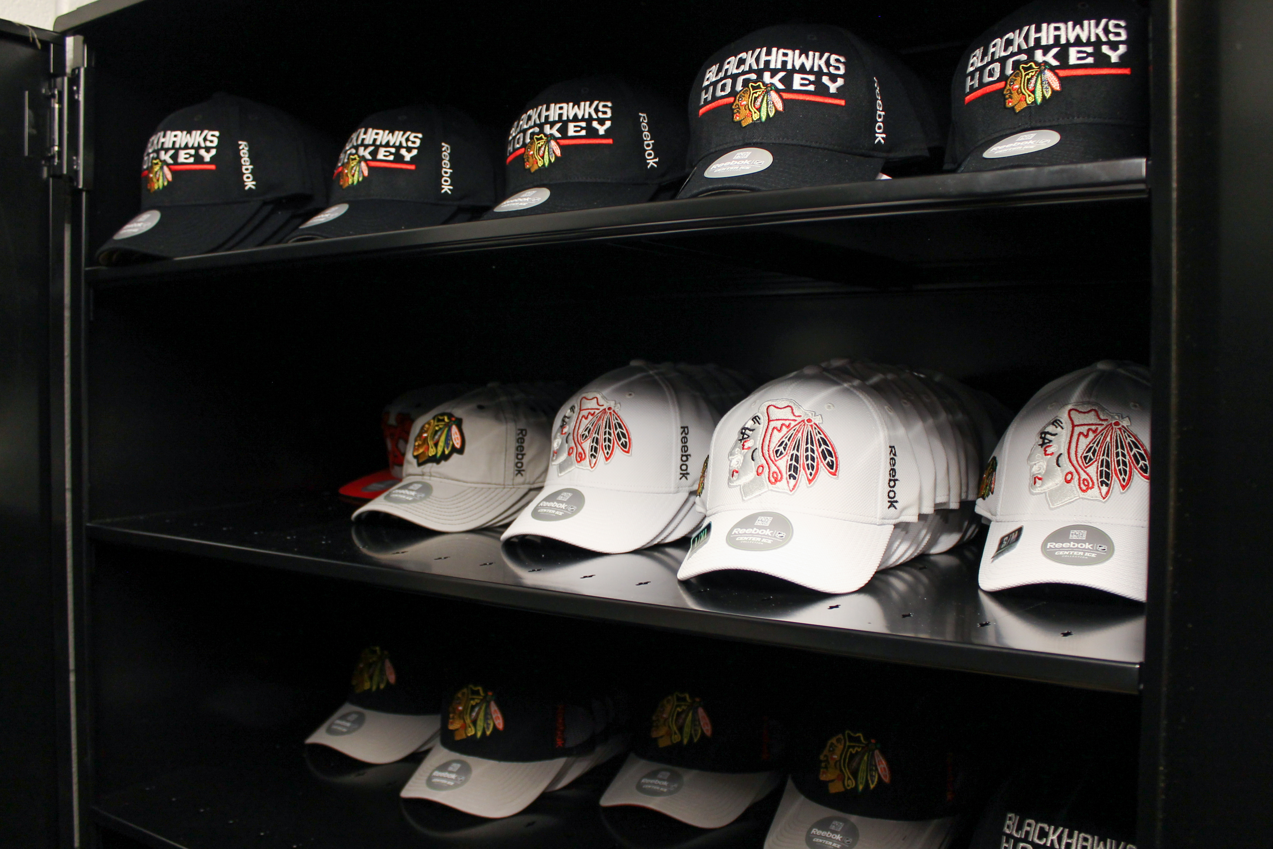 Athletic apparel stored in 4-post shelving with lockable doors