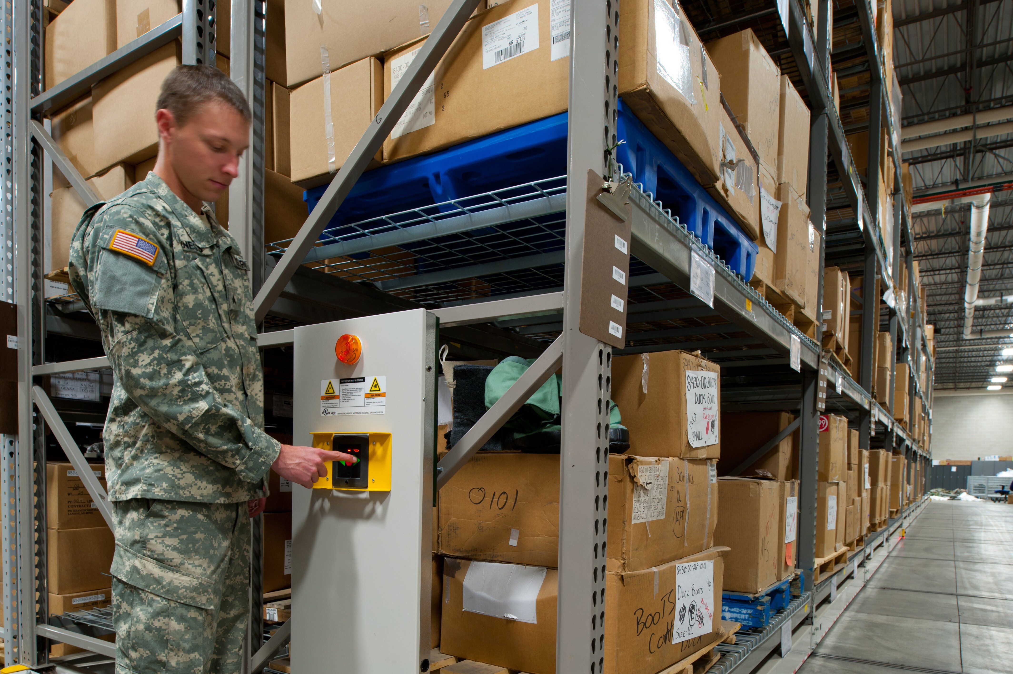 National Guard Soldier operating powered Heavy-Duty Mobile storage system