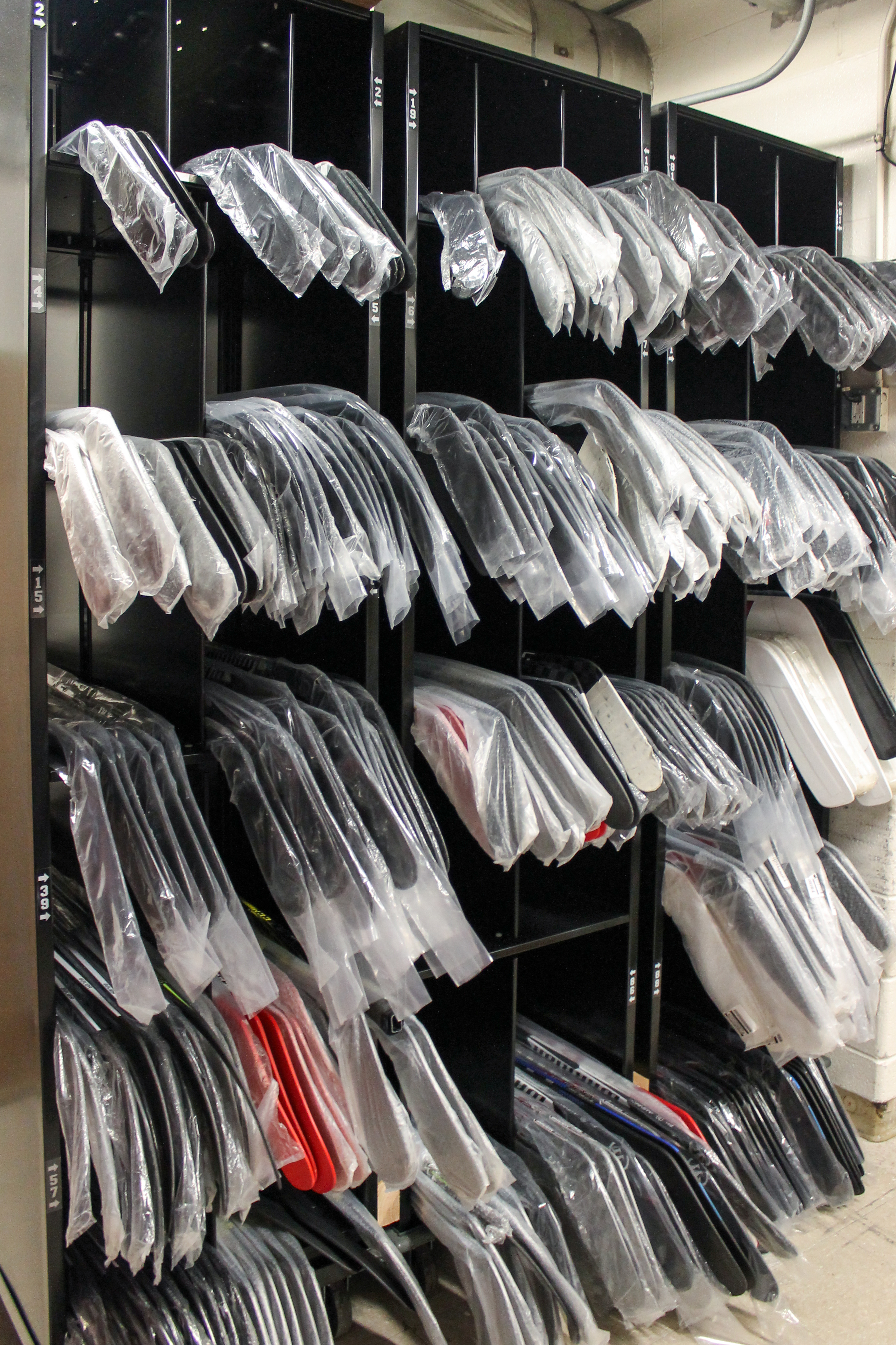 Hockey sticks stored on 4-post bin shelving system