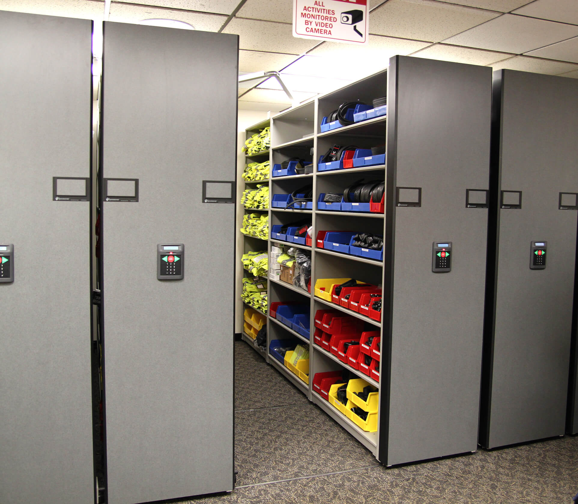 Taser cartridges in bin storage on powered compact shelving at Aurora Police Department